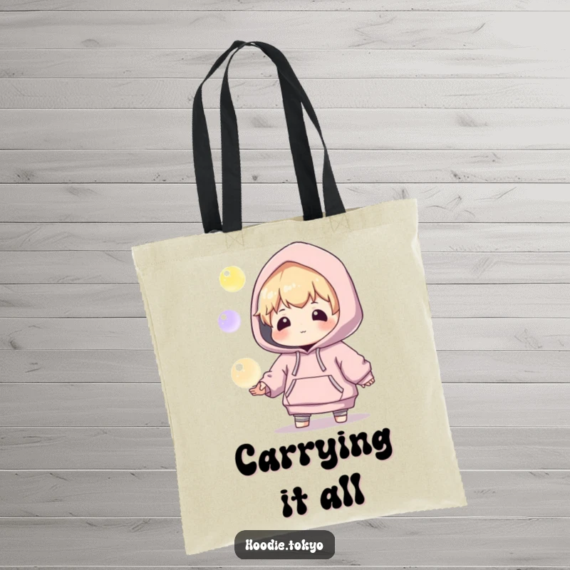 Funny tote bag showcasing a playful character in an oversized hoodie, attempting to juggle three luminous, glowing orbs with focus.
